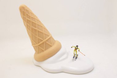 a Skier skiing downhill white icing on an ice cream cone.