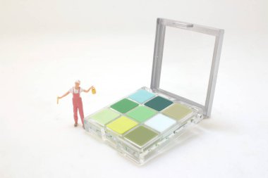 eyeshadows in plastic box isolated with paint figure
