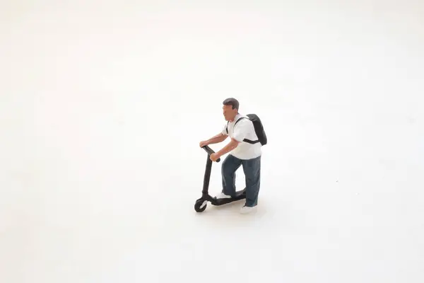 a figure Person riding an electric scooter,