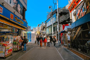 Şehir merkezinde kalabalık bir cadde. Şehir içinde yürüyen insanlar var. 28 Kasım 2023