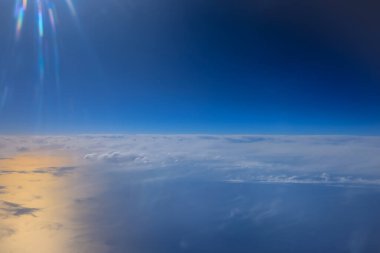 Uçak penceresinden bak. Su yüzeyindeki bulutlar.