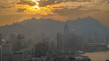 5 Ocak 2025, sıcak günbatımı renkleriyle örtülmüş hareketli bir şehrin gökyüzü manzarası,