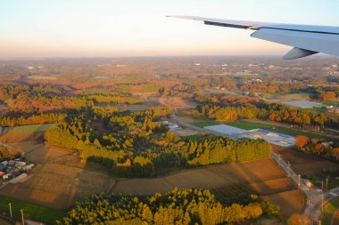 Dec 3 2024 view showcasing a cityscape featuring a calm river, expansive fields, clipart