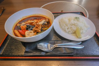 Sebzeli çorba ve et tabağın yanında servis edilir.