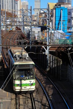 6 Aralık 2024, modern şehirlerle çevrili hareketli bir bölgede raylar üzerinde seyahat ediyor.