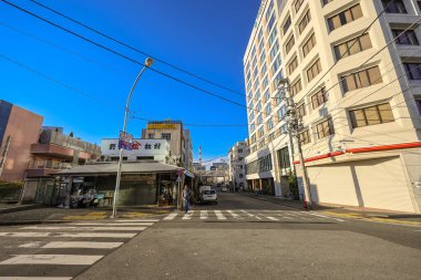 Modern ve geleneksel bina 7 Aralık 2024 'ün yanında canlı bir cadde sergileniyor.