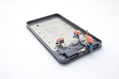 Elektronik bileşenler üzerinde çalışan bir minyatür figür