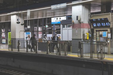 Modern bir tren istasyonunda tren istasyonunda bekleyen yolcular,