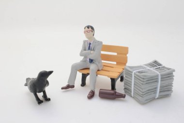 Minyatür heykelcikler, elinde karga olan resmi bir adamı tasvir ediyor.