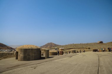 Eski toprakların yakınındaki engebeli bir arazide yürüyen bireyler,