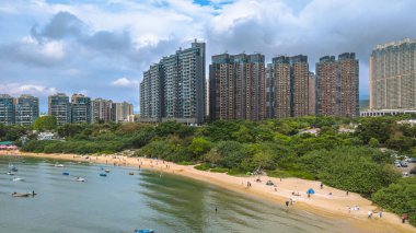 Sakin sularla çevrili yeşil ormanları olan sakin adalar, kentsel gökdelenler