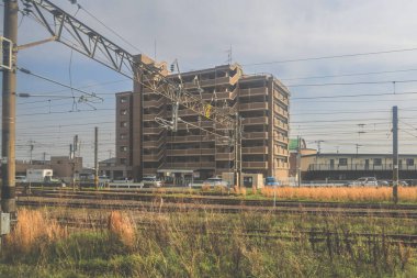 28 Mart 2025 'te tren raylarının yanında bir apartman dairesi görünüyor.