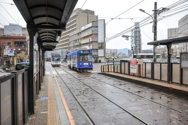 28 Mart 2025 renkli tramvay kalabalık bir şehir bölgesindeki bir istasyonda durdu.