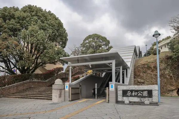 28 Mart 2025 girişinde taş basamaklar, yeşillik ve yürüyen merdiven var.