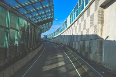 Çağdaş üstgeçit yapılarıyla çevrili kıvrımlı kentsel yol camlı.