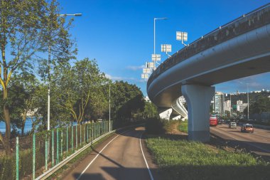Çağdaş üstgeçit yapılarıyla çevrili kıvrımlı kentsel yol camlı.