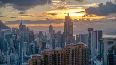 Dağlarla çevrili yüksek binaların yer aldığı şehir silueti