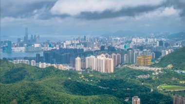 Yüksek binalar orman tepeleriyle Hong Kong 'un ufuk çizgisine hakim.