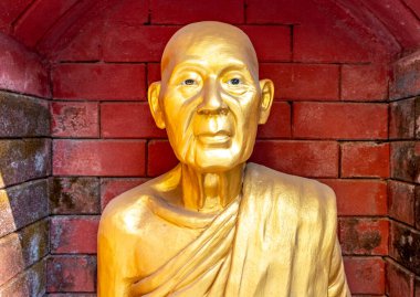 Golden statue at a landmark Buddhist temple in Mae Sot Thailand
