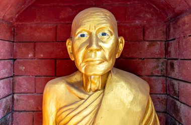 Golden statue at a landmark Buddhist temple in Mae Sot Thailand