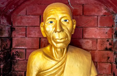 Golden statue at a landmark Buddhist temple in Mae Sot Thailand