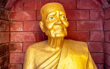 Golden statue at a landmark Buddhist temple in Mae Sot Thailand