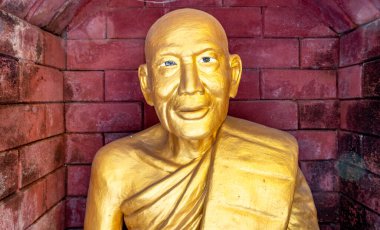 Golden statue at a landmark Buddhist temple in Mae Sot Thailand