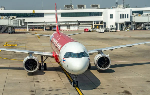 Stock image Thai Air Asia passenger jetliner taxis to the gate at Don Muaeng Airport in Bangkok