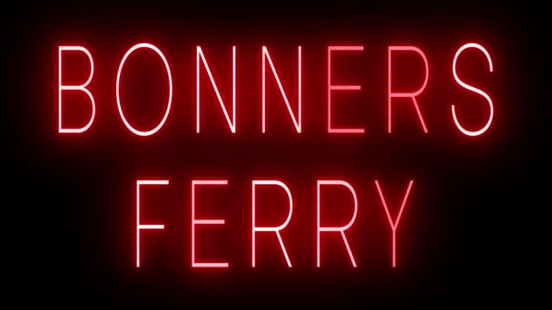 赤いレトロスタイルのネオンサインは Bonners Ferryの黒い背景に輝いています — ストック動画