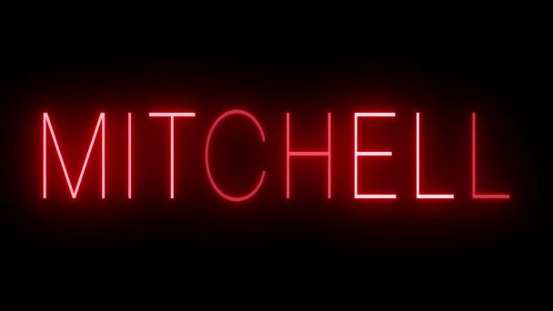 赤いレトロスタイルのネオンサインはMitchellの黒い背景に輝いています — ストック動画