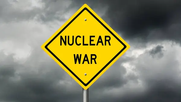 Yellow diamond highway sign with words NUCLEAR WAR