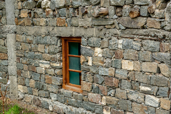 Stone wall and wooden window frame in the village of Turtuk in northern India along the borders with Tibet and Pakistan in the Himalayas