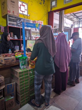 Alışveriş müşterileri aldıkları yiyeceklerin parasını ödemek için sırada bekliyorlar. Doğu Kalimantan, Endonezya, 23 Aralık 2022.