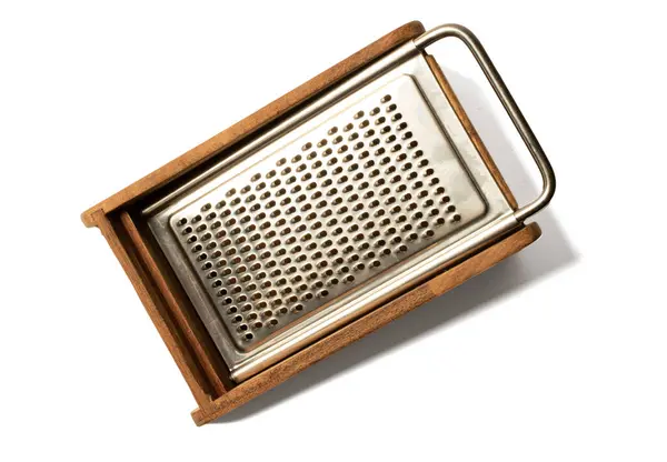 cheese grater spices and food, classic wooden and metal kitchen utensil on white background,vintage kitchen utensil on white isolated copyspace.shredder, kitchenware, parmesan cheese, pattern, cookery