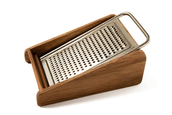cheese grater spices and food, classic wooden and metal kitchen utensil on white background,vintage kitchen utensil on white isolated copyspace.shredder, kitchenware, parmesan cheese, pattern, cookery, shiny, metallic, closeup, macro, cuisine, 