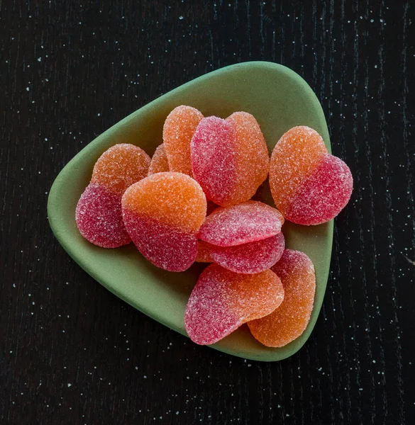 a group of jelly candies on wooden background