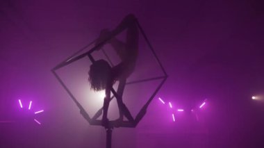 Yetenekli bir sanatçı bir küp içinde akrobatik numaralar sergiliyor.