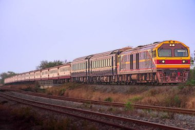 Passenger train by diesel locomotive on the railway.