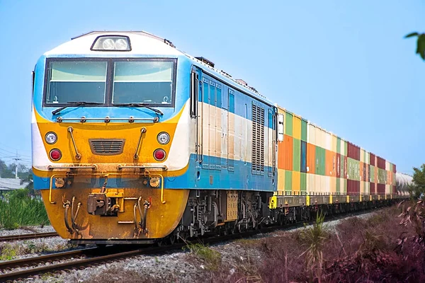 stock image Container-freight train by diesel locomotive on the railway.