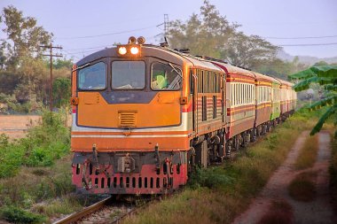 Passenger train by diesel locomotive on the railway.