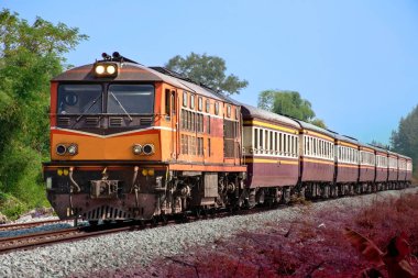 Passenger train by diesel locomotive on the railway.