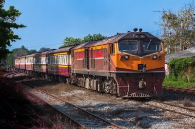 Passenger train by diesel locomotive on the railway.