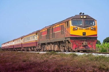 Passenger train by diesel locomotive on the railway.