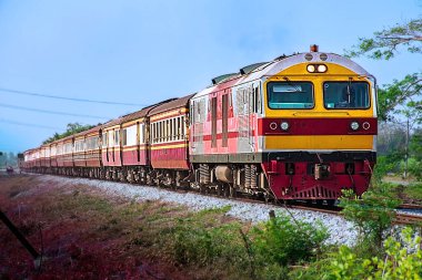 Passenger train by diesel locomotive on the railway.