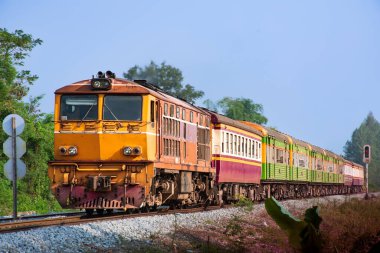 Passenger train by diesel locomotive on the railway.