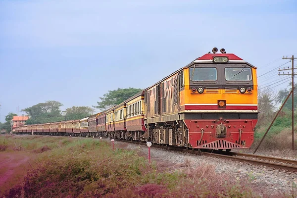 stock image Passenger train by diesel locomotive was passing the railway curve.