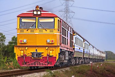 Passenger train by diesel locomotive on the railway.