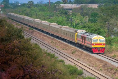 Passenger train by diesel locomotive on the railway.