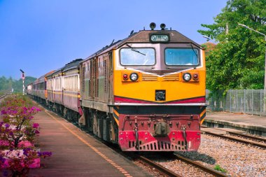 Passenger train by diesel locomotive on the railway.