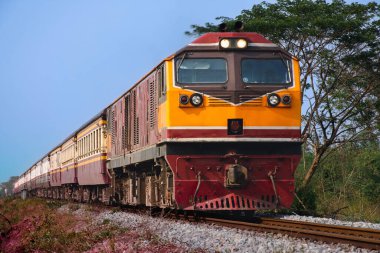 Passenger train by diesel locomotive on the railway.
